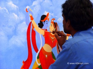 Artist Painting Picture of Radha Krishna