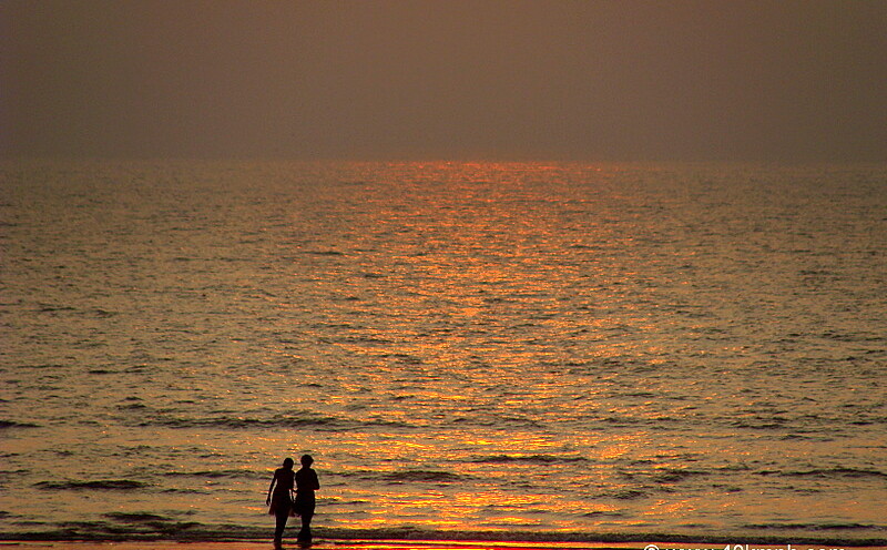 Friends Walking along the Juhu Beach at Sunset