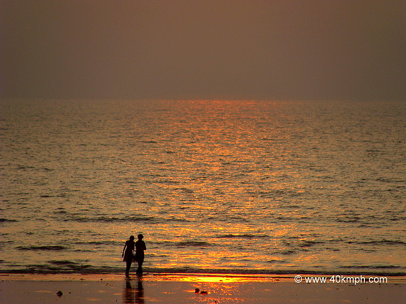 Friends Walking along the Juhu Beach at Sunset