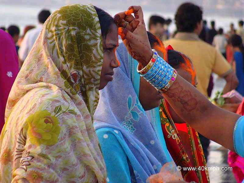Woman Applying Vermillion during Chhath Festival at Juhu Beach