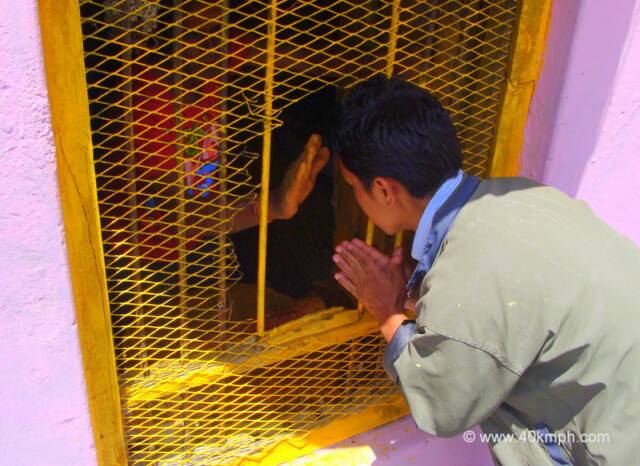 Man Applying Sandalwood Saffron Paste on Devotee's Forehead at Badrinath, Uttarakhand, India