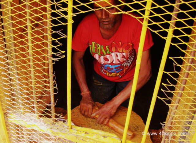 Man Preparing Sandalwood Saffron Paste for Devotees nearby Garud Shila, Badrinath, Uttarakhand, India