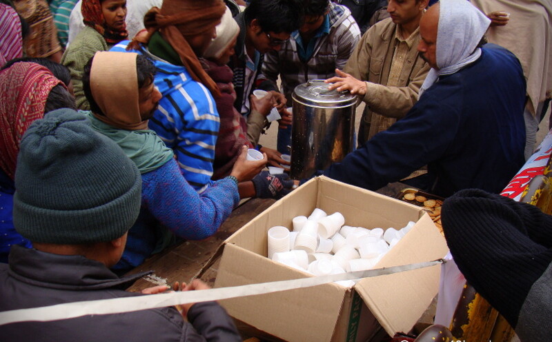 Free Tea and Biscuits for Pilgrims on the Occasion of Makar Sankranti at Dashashwamedh Ghat Road, Varanasi, Uttar Pradesh, India