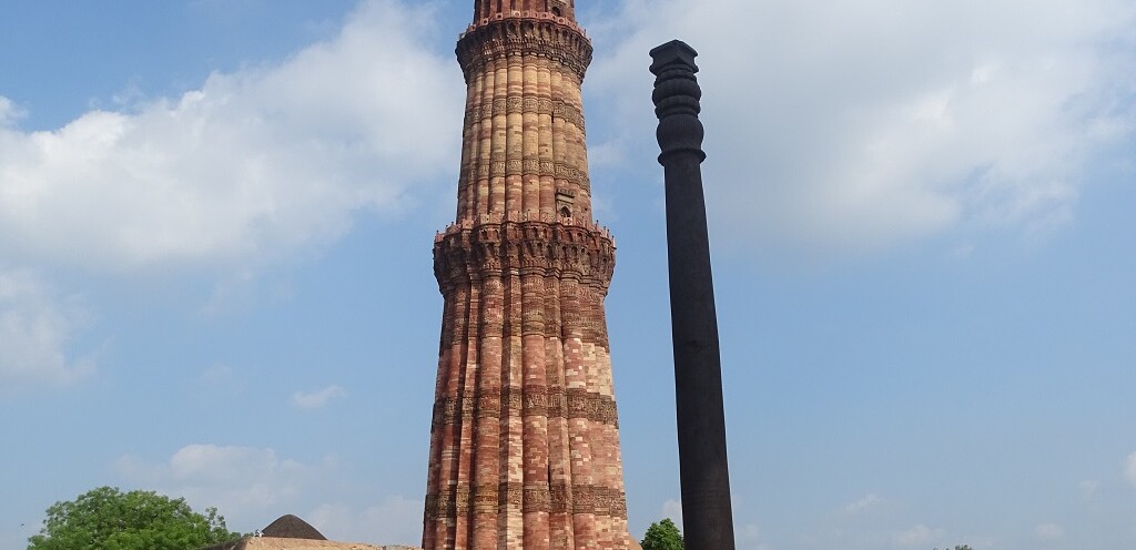 Iron Pillar and Qutb Minar at Qutb Complex, Delhi, India